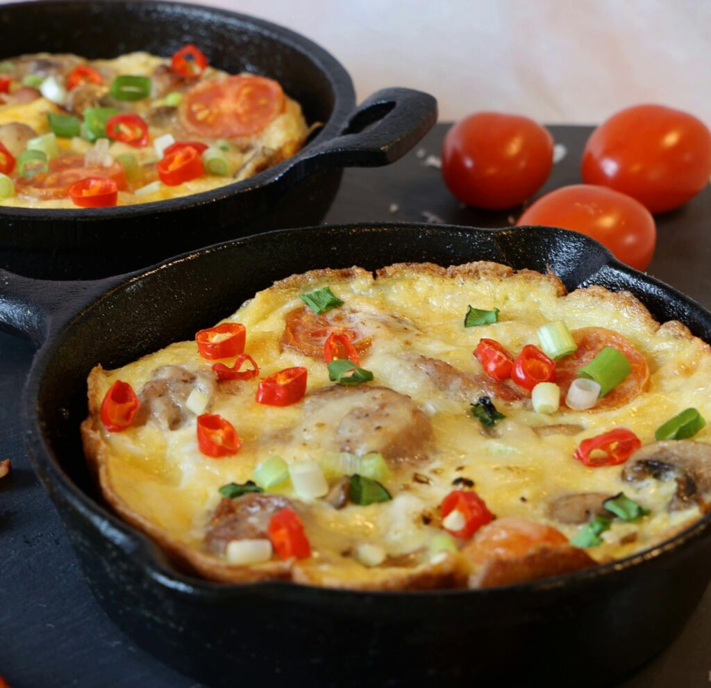 Mouthwatering homemade vegetable frittata cooked in a cast iron skillet with fresh ingredients.