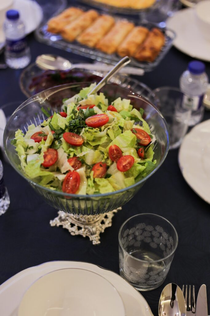 A vibrant bowl of fresh vegetable salad with cherry tomatoes, perfect for a healthy meal setting.
