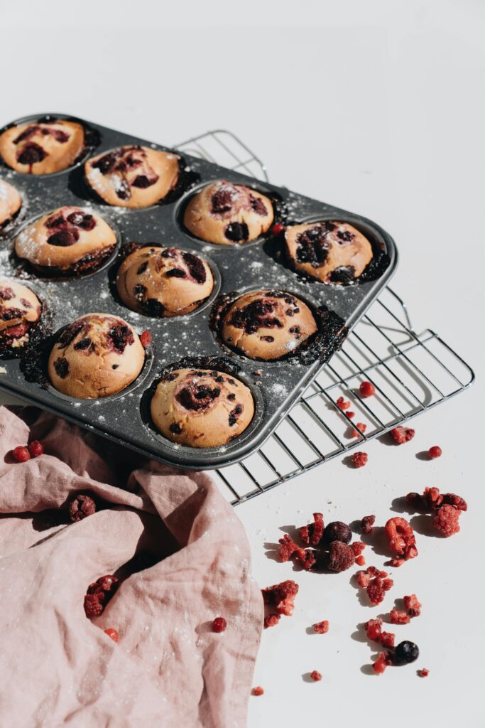 Delicious homemade berry muffins in a baking tin, perfect for a snack.