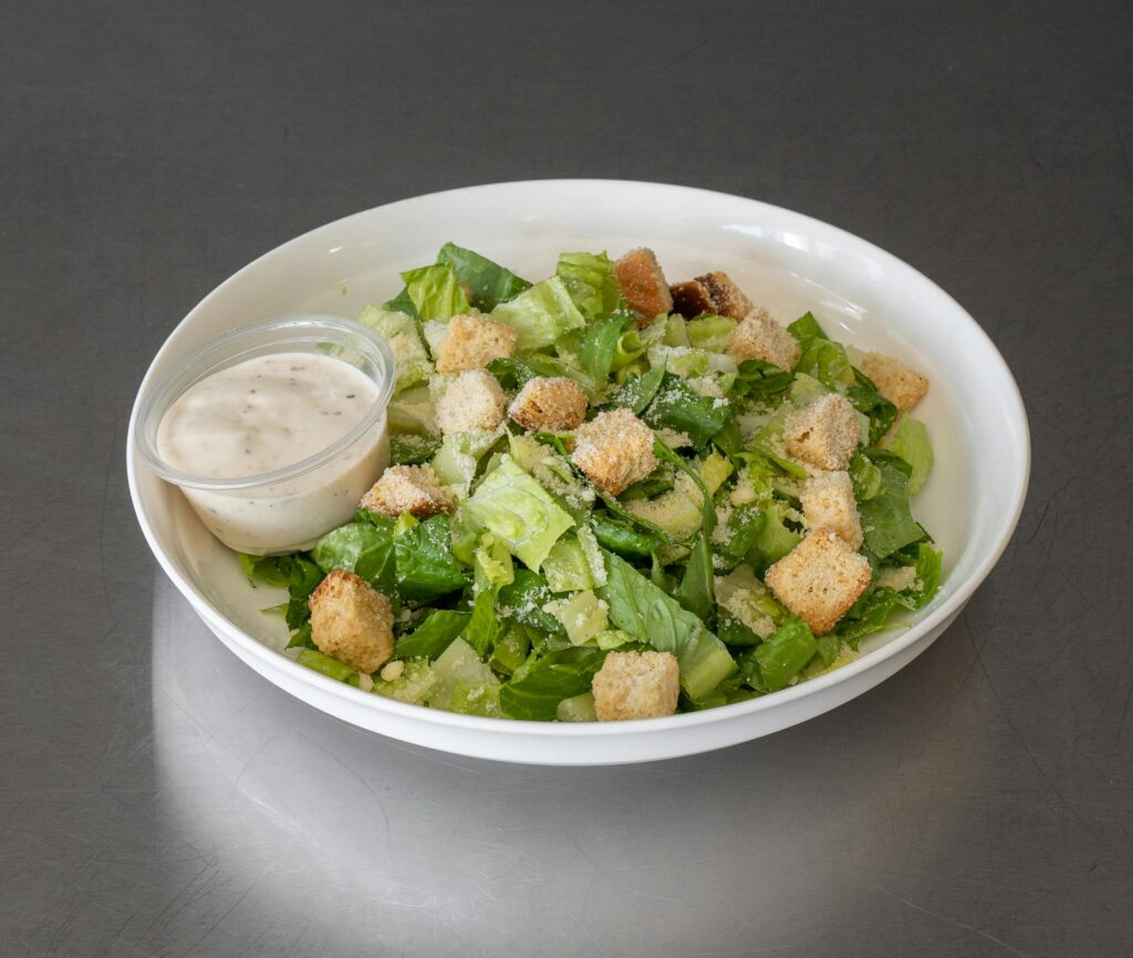 Fresh Caesar salad with croutons and dressing, perfect for a healthy meal.